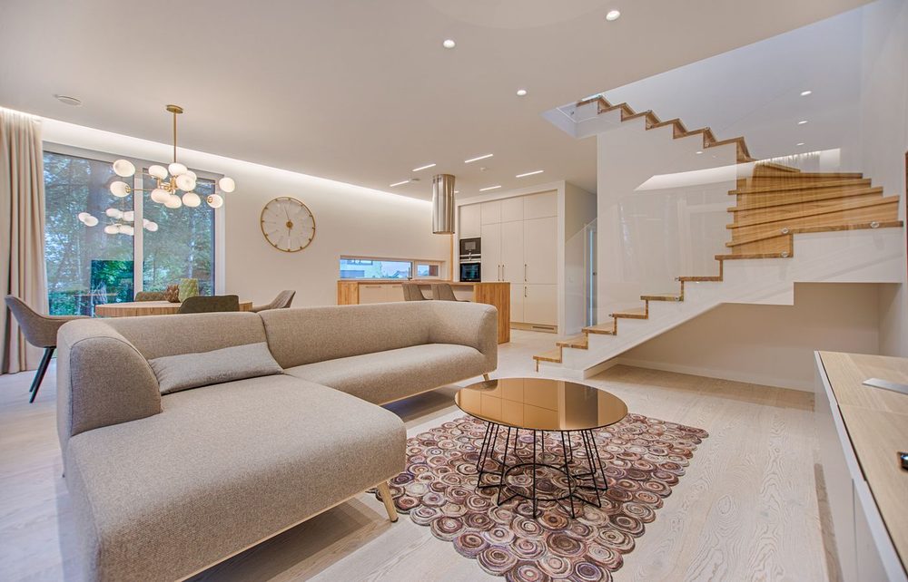 Elegant, sunlit modern living room interior of a luxury residence